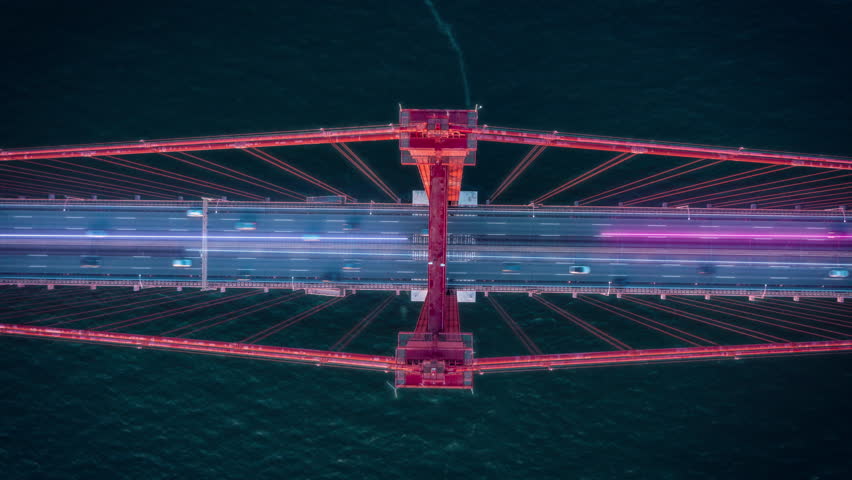 Futuristic aerial view of traffic crossing a bridge. Glowing digital overlay lines representing data flow and network connection - Powered by Shutterstock - Get 15% off with code: PIKWIZARD15
