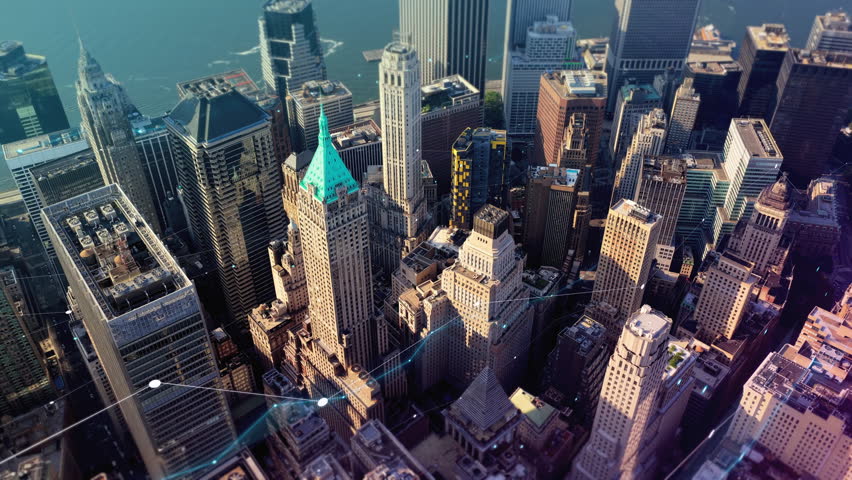 Aerial view of a financial district showing urban network technology. Glowing lines illustrate data streaming through futuristic smart city