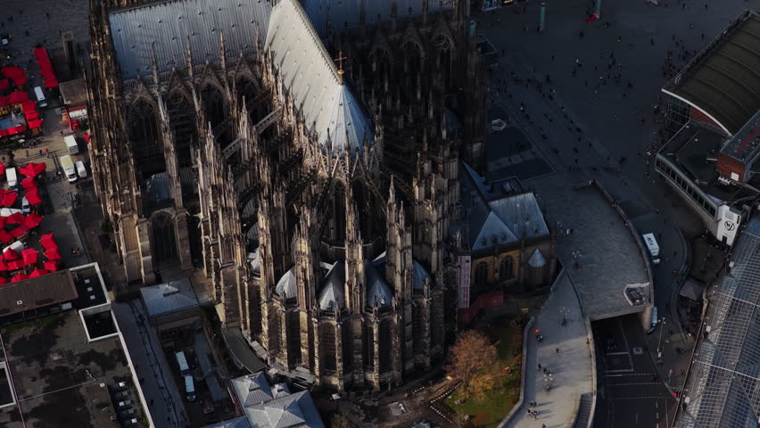 Top down aerial view of famous Cologne Cathedral, a masterpiece of gothic architecture. People walking on main square of the city