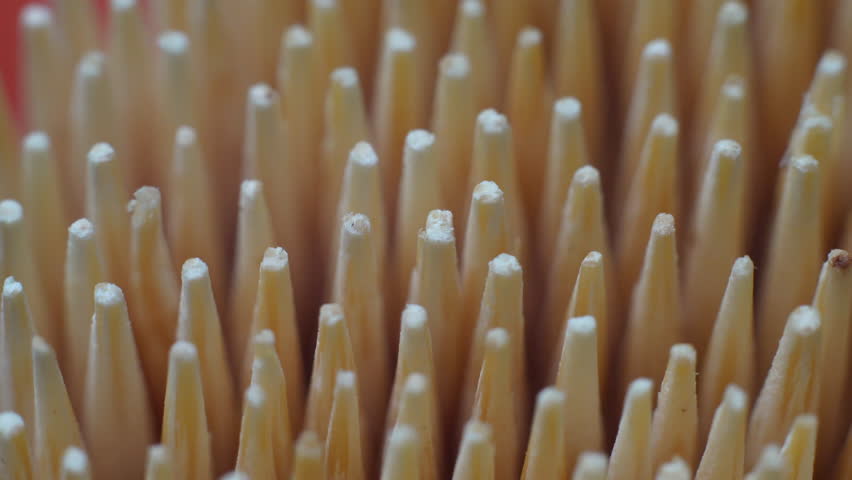 A close-up of toothpicks in a container, ideal for a variety of culinary and crafting purposes