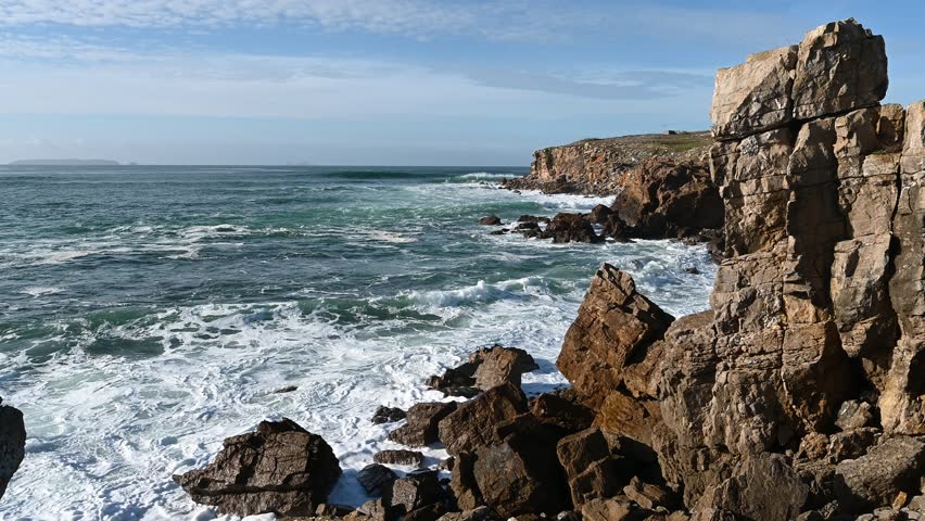 Breaking Atlantic waves hit rugged cliff formations along the Peniche coastline, filmed on November 9 2025 