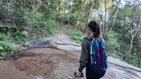 a woman walks along an obstacle course in a rope forest, carry the rope across the waterfall - Powered by Shutterstock - Get 15% off with code: PIKWIZARD15
