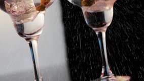 Spray starting between two cocktail glasses, droplets forming streaks, showing split tone contrast. Martini, stemware, limes, olives, skewers, garnish, studio - Powered by Shutterstock - Get 15% off with code: PIKWIZARD15