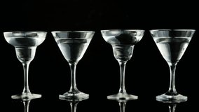 Confetti falling, olives dropping into martini glasses, causing splash and overflow showing motion. Glass, cocktail, reflective, stemmed, green, tabletop, minimalist - Powered by Shutterstock - Get 15% off with code: PIKWIZARD15