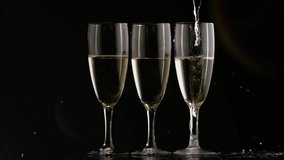 Pouring stream from above shifting over 3 flutes making bubbles, creating foamy heads, flare moving. Stemware, champagne, sparkling, reflections, minimalist, studio, elegance - Powered by Shutterstock - Get 15% off with code: PIKWIZARD15