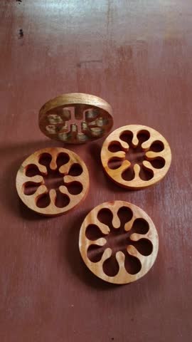 Wooden Coasters on a brown surface, showcasing their unique floral cutout design. Perfect for home decor, craft, and product advertising.