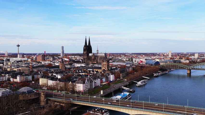 Panoramic aerial footage showing the Rhine river and historic city center of Cologne, Germany, with its iconic Gothic cathedral