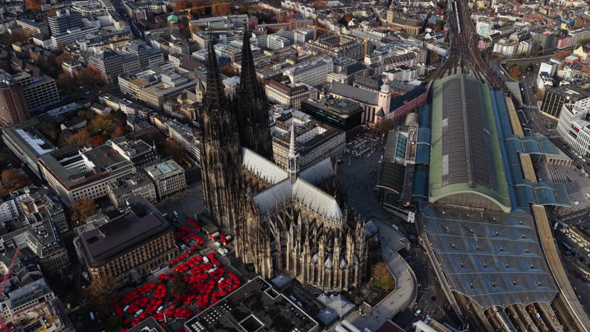 Aerial views capturing grandeur of Cologne Cathedral, bustling central train station, and expansive cityscape during Christmas time