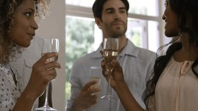 Three friends by window releasing gold confetti, raising flutes and celebrating for event marketing. Celebration, toast, champagne, laughter, home, vibrant, sunlit - Powered by Shutterstock - Get 15% off with code: PIKWIZARD15