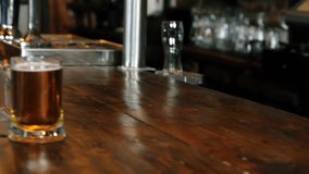 Pullback showing woman at bar turning to man having friendly chat with beers gold confetti drifting. Pub, warm, rustic, duo, conversation, ambience, taps - Powered by Shutterstock - Get 15% off with code: PIKWIZARD15