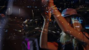 Woman performing music set raising red prop adjusting grip singing into mic reflecting city lights. Performer, tambourine, percussion, microphone, rooftop, urban, nightlife - Powered by Shutterstock - Get 15% off with code: PIKWIZARD15