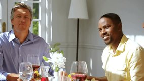 Mature man in blue shirt smiling at table, red hearts popping over glasses, guests celebrating food. Dining, wine, centerpiece, vibrant, warmth, joy, overlay - Powered by Shutterstock - Get 15% off with code: PIKWIZARD15