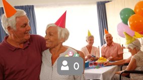 Senior man and woman responding to livestream count climbing kissing, hugging as avatars clustering. Partyhats, balloons, cake, gifts, lounge, celebration, festive - Powered by Shutterstock - Get 15% off with code: PIKWIZARD15