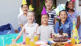 Six kids standing at porch table confetti falling overhead causing cheering for cake. Children, celebration, party, balloons, hats, outdoor, vibrant - Powered by Shutterstock - Get 15% off with code: PIKWIZARD15