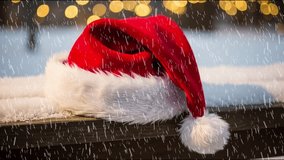 Red Santa Hat on Snowy Bench with Falling Snow and Festive Bokeh Lights - Powered by Shutterstock - Get 15% off with code: PIKWIZARD15