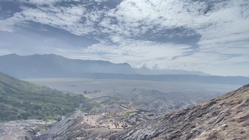 Cinematic wide shot of Mount Bromo in East Java, Indonesia, showcasing its dramatic volcanic landscape and natural beauty. Perfect for travel videos, documentaries, dan nature films 4k