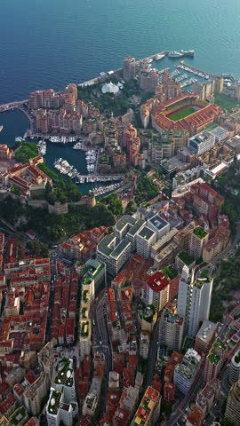  Birds eye aerial view of traffic in Monte Carlo, Monaco. Famous formula one Grand Prix Circuit. Aerial view of the city of Monaco. Establishing shot showcases luxury yachts moored in Monaco bay