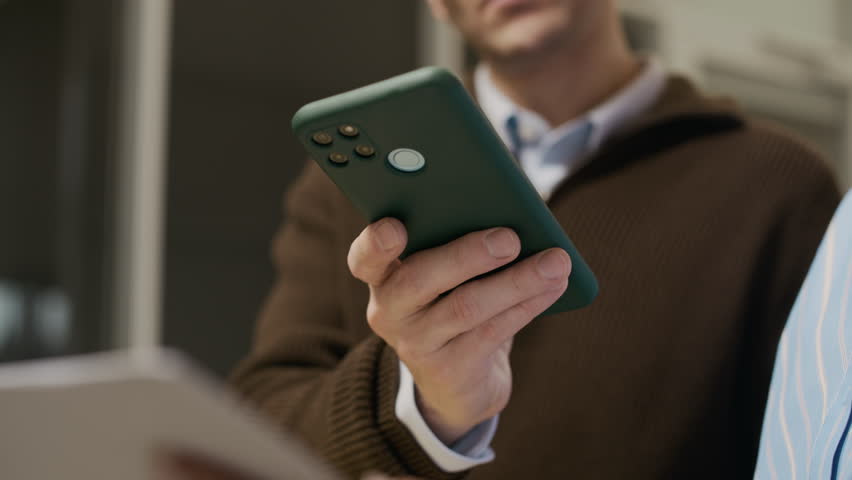 Low angle shot of unrecognizable office worker taking picture of paper with bright flash