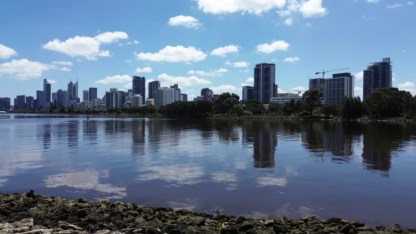 Aerial Perth, Western Australia City Skyline footage. Panoramic views of the city, the Swan River, South Perth and the southern suburbs. Central business district and sports fields. 