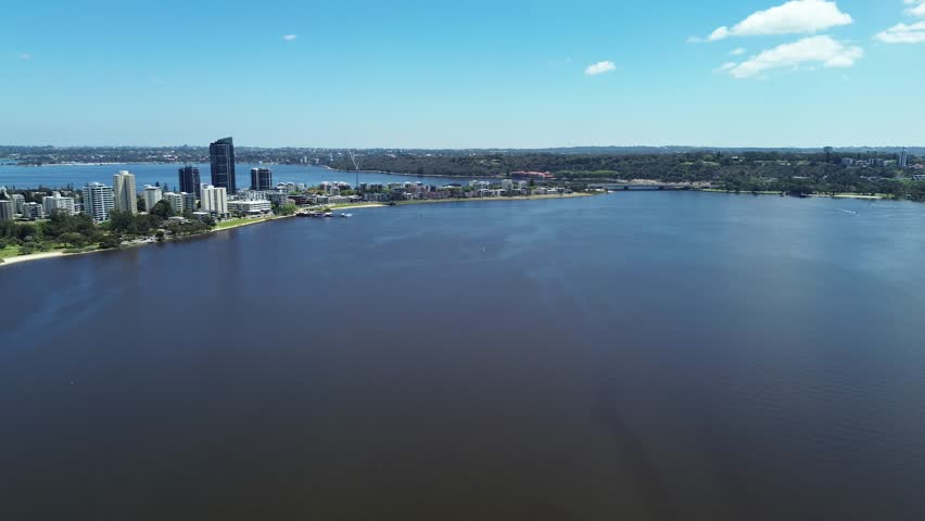 Aerial Perth, Western Australia City Skyline footage. Panoramic views of the city, the Swan River, South Perth and the southern suburbs. Central business district and sports fields. 
