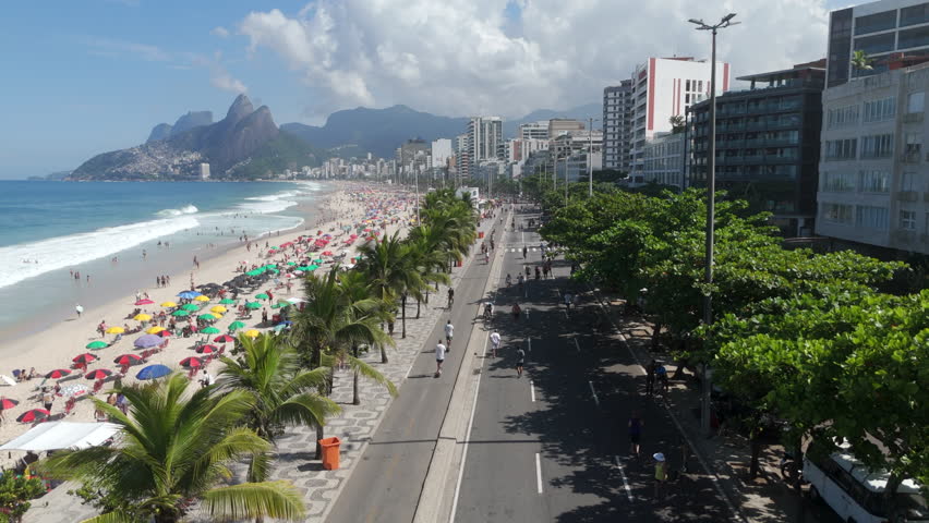 Aerial view of Ipanema beach in Rio de Janeiro, Brazil. On Sundays, the car lanes closest to the beach are closed to motor vehicles and transformed into a large promenade for pedestrians.