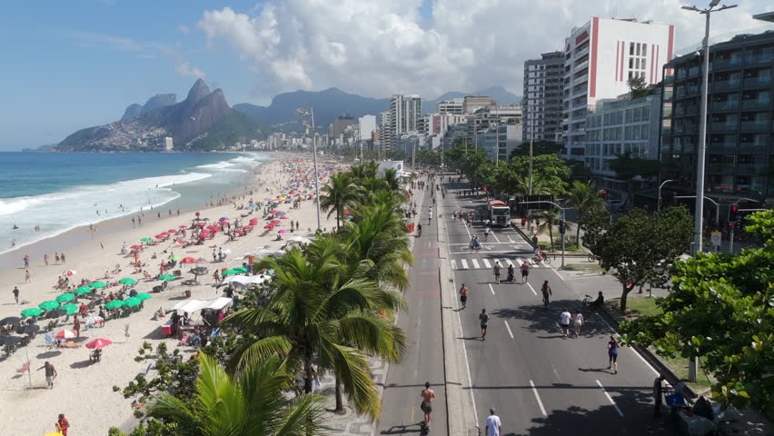 Aerial view of Ipanema beach in Rio de Janeiro, Brazil. On Sundays, the car lanes closest to the beach are closed to motor vehicles and transformed into a large promenade for pedestrians.