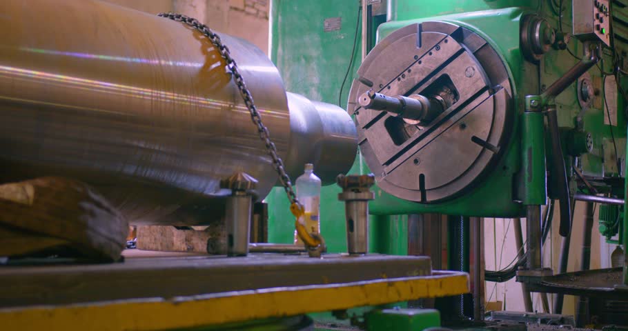 Preparation for processing a large metal part in a turning shop. Heavy industry as a means of achieving progress in the economy. 25 fps 4k video.