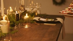 A detailed 4K view of a star-stacked gingerbread cookie tree centerpiece being placed on a beautifully set festive holiday table. - Powered by Shutterstock - Get 15% off with code: PIKWIZARD15