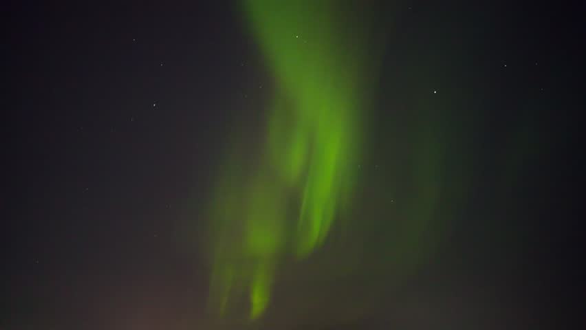 Abstract green Northern Lights (Aurora Borealis) dancing across a dark starry night sky. The video is sped up 2 times but it is 47.952 fps so can be brought back to 23.98 fps.
