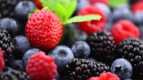 Fresh Berries. Various colorful berries rotating background. Mint leaves, Strawberry, Raspberry, Blackberry, Blueberry close-up, slow motion backdrop. Fresh Bio Fruits, Healthy eating, diet - Powered by Shutterstock - Get 15% off with code: PIKWIZARD15