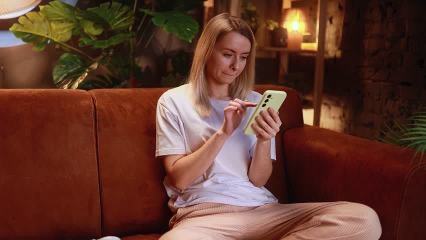 Portrait of woman browse products in internet online shopping store planning trip travel or swiping through profiles on dating app on smartphone at home Choice concept