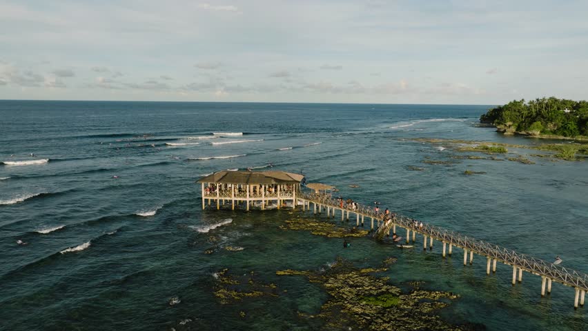 Aerial view of Cloud 9 Surfing Area with surfers catching waves nearby. Siargao, Philippines. Cloud 9 Surfing Area.