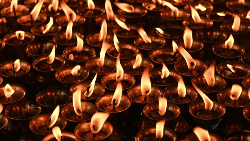 Light candles in Swayambhunath temple, Nepal. The faithful also light candles as a sign of gratitude to God for answered prayers.