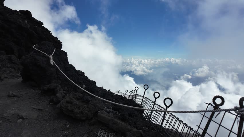 Mount Fuji, Kitayama, Fujinomiya, Shizuoka, Japan, Mountain landscape above clouds with fence posts on ridge
