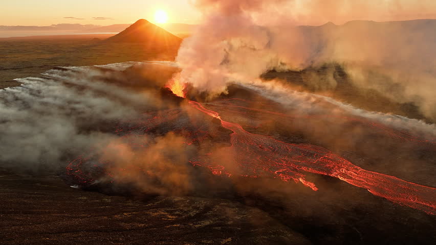 Volcanic eruption, red burning lava erupts from ground, drone fly over active volcano crater in Iceland
