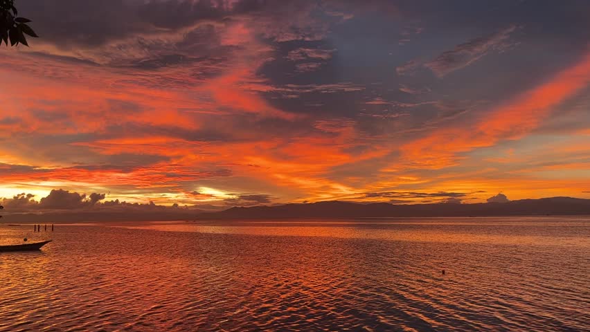 Beautiful sunset on the beach with orange light and blue sky