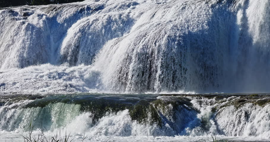 Beautiful waterfall cascading over rocks with splashing water 