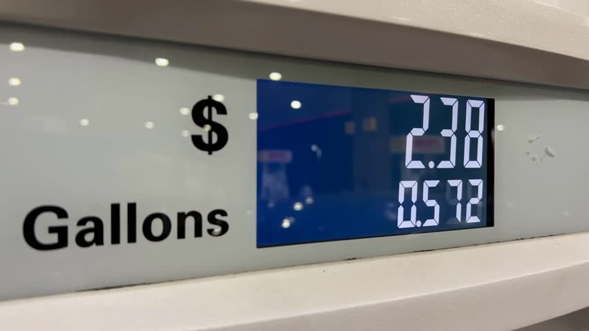 Close-up of a digital gas pump counter rising, showing fuel consumption and increasing gas prices, highlighting energy costs and financial impact.