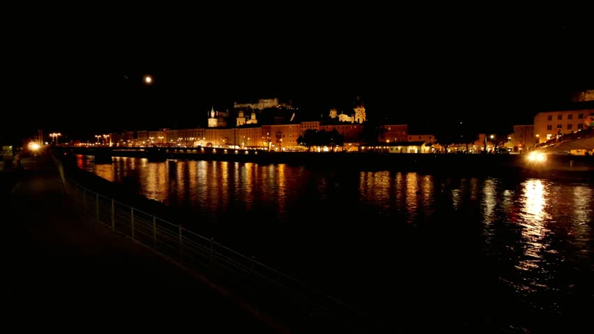 Nighttime cityscape view of Salzburg Austria with reflections on the Salzach river