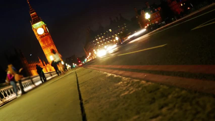 Big ben and westminster bridge at night with traffic and pedestrians in london uk