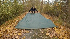 Tent tarp outdoor camping gear dismantle outside forest in autumn fall season - Powered by Shutterstock - Get 15% off with code: PIKWIZARD15