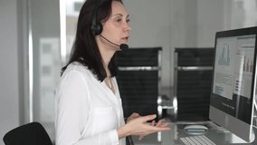 Woman wearing headset communicating during online, providing customer service or remote it support in a modern office environment, engaging in virtual meeting. Business people concept - Powered by Shutterstock - Get 15% off with code: PIKWIZARD15