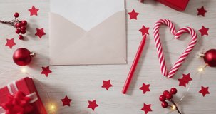 Script overlay appearing, causing neon red text over envelope, zooming, inviting clicks. Holiday, flatlay, gift, ornament, candy, berries, lights - Powered by Shutterstock - Get 15% off with code: PIKWIZARD15