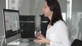 Woman wearing headset communicating during online, providing customer service or remote it support in a modern office environment, engaging in virtual meeting. Business people concept - Powered by Shutterstock - Get 15% off with code: PIKWIZARD15