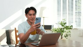 Lifestyle people, Man using laptop computer and smartphone and enjoys a coffee. Happy man, entrepreneur, small business owner working online at home office. - Powered by Shutterstock - Get 15% off with code: PIKWIZARD15