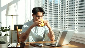 Lifestyle people, Man using laptop computer and smartphone and enjoys a coffee. Happy man, entrepreneur, small business owner working online at home office. - Powered by Shutterstock - Get 15% off with code: PIKWIZARD15
