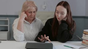 Teenage granddaughter patiently guiding elderly grandmother through tablet usage, bridging digital generation gap with warmth and understanding in comfortable home setting - Powered by Shutterstock - Get 15% off with code: PIKWIZARD15