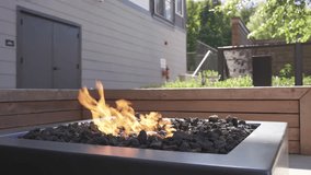 Modern Gas Fire Pit with Burning Flames on Outdoor Patio Deck - Powered by Shutterstock - Get 15% off with code: PIKWIZARD15