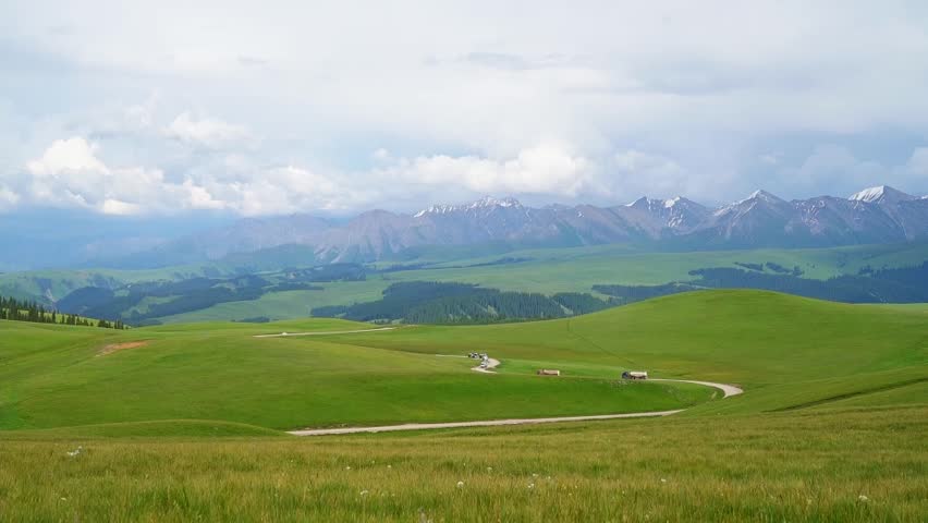 Grassland and mountains in a sunny day, in Kalajun grassland, xinjiang, China 4k