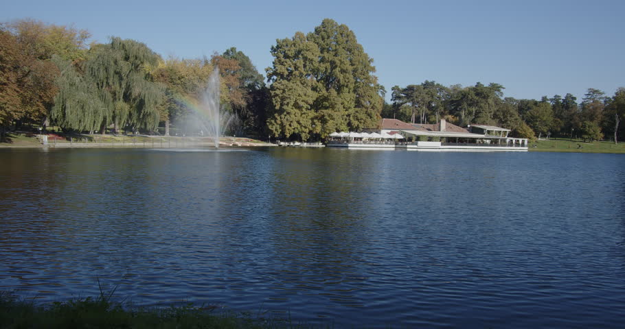 Craiova park pond and water spraying fountain 4K video